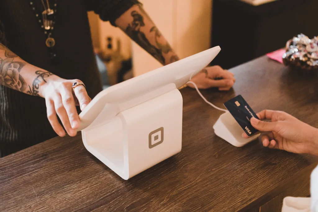 person holding white POS machine